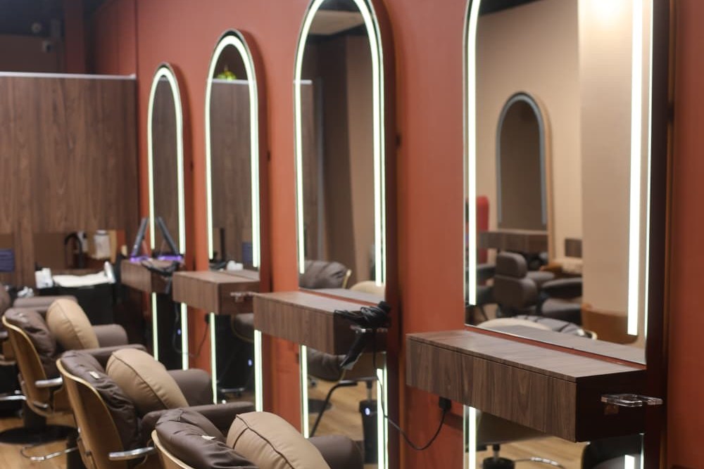 Styling chairs beneath arched brass mirrors at One Degree Edit, Havelock 2
