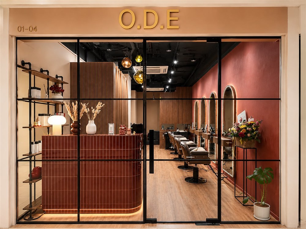 Reception desk with maroon tile counter and brass trim at One Degree Edit, Havelock 2